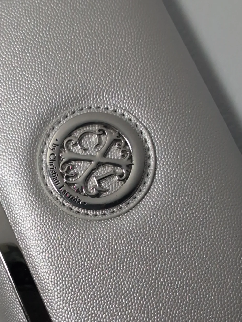 CXL Silver Metallic Clutch with Decorative Logo Emblem